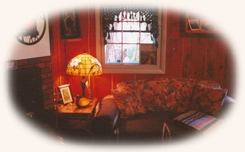 Cottage Living Room. Antique Furnishings. Gas Fireplace. Tiffany Lamps at gathering light ... a retreat located in southern oregon near crater lake national park, haven for birders 
near the klamath basin birding trails. cabins, tree houses, rv camping and vacation rentals in the forest on the river near crater lake national park and klamath basin birding trails.